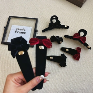 Elegant red and black velvet bow hair claw clip set with gold logo detail for women