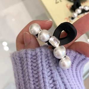 Elegant mini matte black hair claw clip with white pearls and a sparkling rhinestone