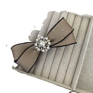 Elegant champagne satin bow hair clip with pearls, rhinestones and sparkling dot accents
