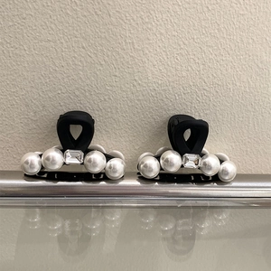 Elegant pair of black matte hair clips with white pearls and center crystal accents