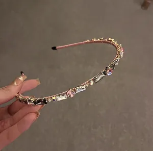 Detail shot of golden metal headband with multi-colored crystals and rhinestones