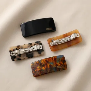 Rectangle acetate hair clips set in black, amber, marble, and tortoiseshell patterns