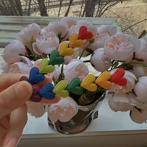 Detail of colorful rainbow heart hair clip with a matte finish for girls hair styling