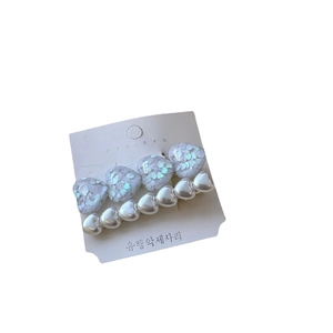 Sweet heart hair clips set with sparkling sequins and faux pearls on display card