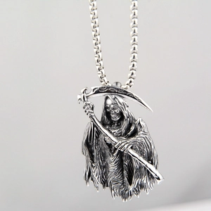 Close-up of vintage stainless steel Grim Reaper pendant with detailed scythe and chain