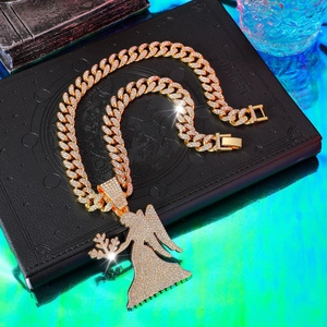 Close-up of hip-hop iced out angel pendant with gold plated Cuban link chain necklace