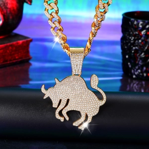 Close-up of hip hop gold bull pendant with iced out rhinestones on a cuban chain