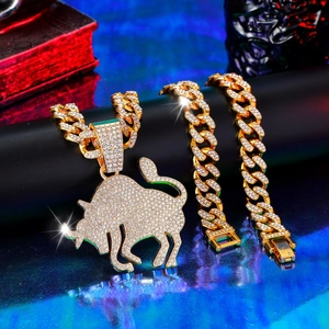Iced-out gold Cuban link necklace and bracelet set with diamond-encrusted bull pendant