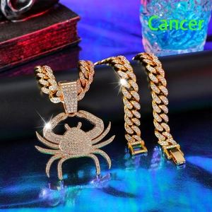 Macro shot of iced out gold Hip-hop Cancer zodiac pendant and thick Cuban link chain