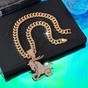 Macro detail of iced-out gold Capricorn pendant with micro-pave crystals on Cuban chain
