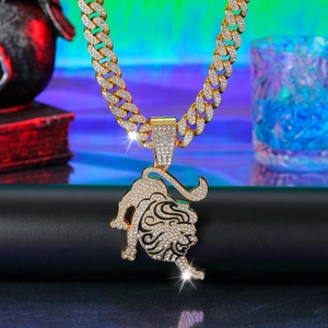 Macro shot of gold-plated iced-out bull pendant with cuban chain on neon background