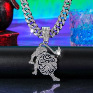Detail of hip-hop iced out bull pendant with glittering stones on heavy Cuban link chain