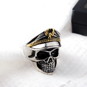 Macro view of vintage silver skull ring wearing a military cap with golden eagle emblem