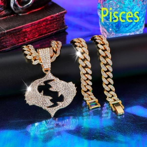 Close-up of iced out Pisces pendant with gold Cuban link chain and bracelet set
