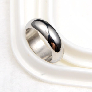 Macro shot of silver polished minimalist hip-hop ring with sleek mirror finish on metal