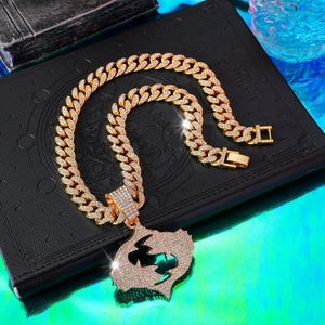 Detail of hip-hop iced out Cuban link chain necklace with gold plating and crystals