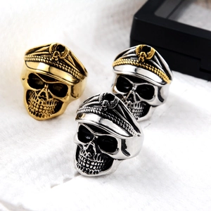 Detail of vintage punk skull military officer rings in gold and silver metal finishes