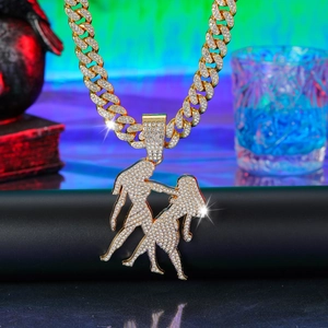 Detail of hip hop cuban chain necklace with gold paved crystal silhouette pendant