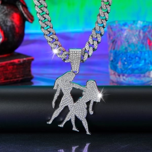 Detailed view of silver iced out Gemini silhouette pendant on heavy Cuban link chain