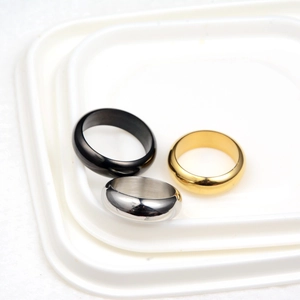 Three-piece set of polished round dome rings in gold, silver, and black stainless steel