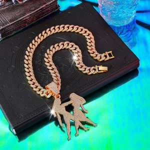 Close-up of hip hop gold Cuban link necklace with iced out rhinestones and double portrait pendant