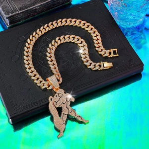 Iced out gold Cuban link chain with detailed crystal-studded bodybuilding muscle pendant