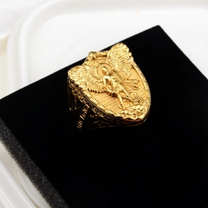 Macro shot of gold St. Michael angel relief and engraved Michael text on vintage shield ring