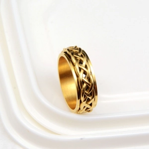 Golden stainless steel spinner ring featuring an intricate woven Celtic knot design