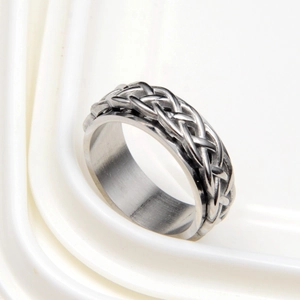 Macro view of Celtic style braided silver band ring with polished inner surface