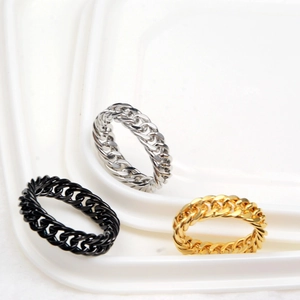Detailed view of curb link chain rings in black, silver, and gold polished stainless steel
