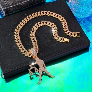 Close-up of gold iced-out Libra pendant with crystal rhinestones on a thick Cuban chain
