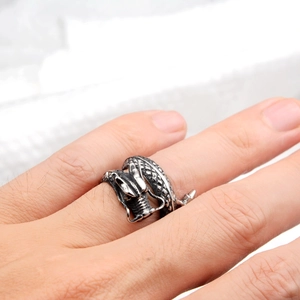 Macro shot of retro dragon open ring on finger showing detailed silver scales and texture