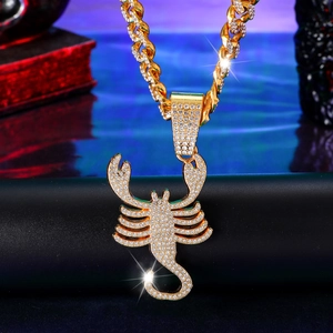 Iced out gold Cuban chain necklace with a Scorpio zodiac scorpion pendant and white crystals