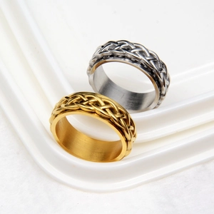 Rotating stainless steel spinner ring with woven celtic knot pattern in gold and silver