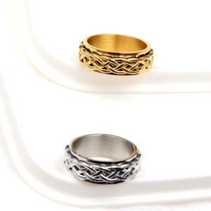 Detail of gold and silver spinning rings featuring intricate woven Celtic style patterns