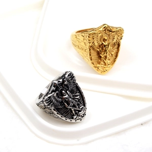 Macro detail of gold and silver shield rings featuring St. Michael archangel relief
