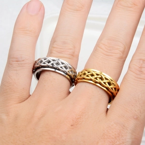 Macro shot of spinning Celtic knot rings in gold and silver stainless steel finish