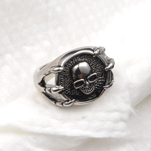 Macro shot of vintage skull ring with dragon claw design and blackened silver finish