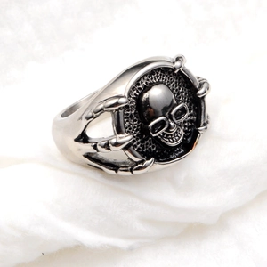 Macro shot of punk style skull ring with eagle claw design in antique silver finish