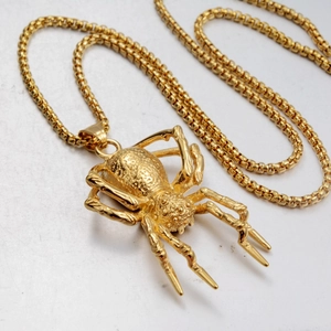 Punk style golden spider pendant necklace with textured spider body and square link chain