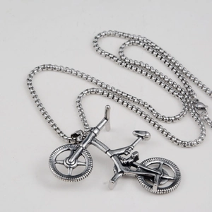 Detailed close-up of antique silver bicycle pendant necklace with durable steel box chain