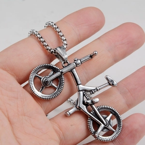 Detailed close-up of a vintage silver bicycle pendant with a sturdy round box chain