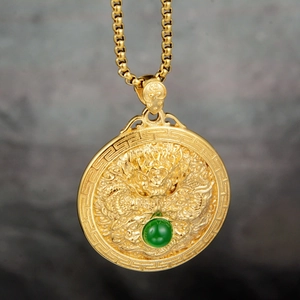 Detail of dragon totem medallion pendant with green bead inlay on gold box chain