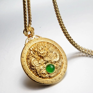 Golden dragon totem round pendant necklace with green gemstone and relief design
