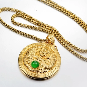 Golden dragon relief pendant necklace with green bead inlay and decorative border