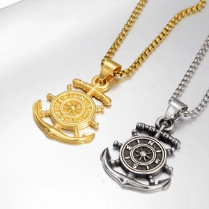Detail of nautical rudder and anchor pendants in gold and vintage silver finish
