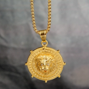 Detailed close-up of a gold embossed lion head medal pendant on a round bead chain
