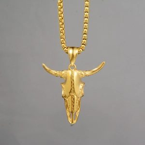 Detailed close-up of golden bull skull pendant with intricate skeletal textures and box chain