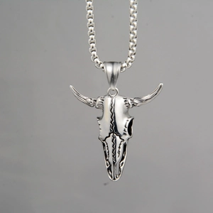 Detail view of retro silver bull skull pendant with punk rock gothic metal textures