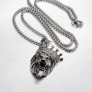 Detailed macro view of punk lion head pendant with crown and sparkling crystal insets